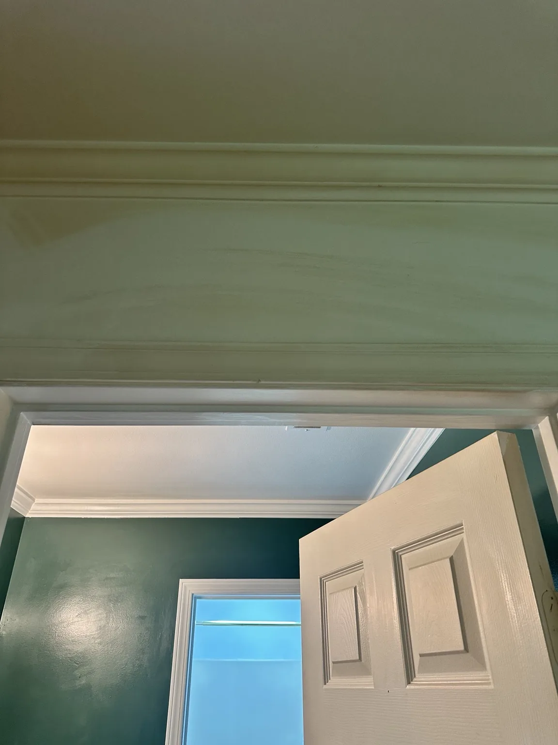 Yellow tobacco residue visible above a doorway before cleaning