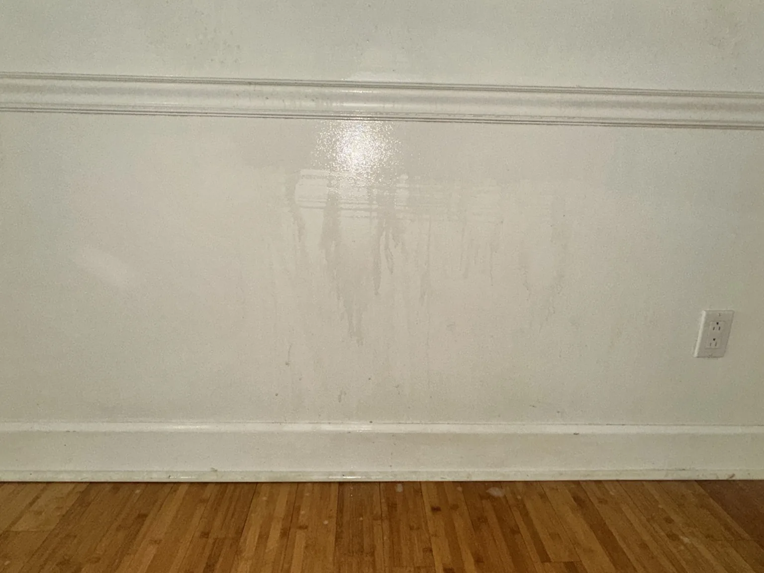 Tobacco-stained wall being washed with a visible clean section